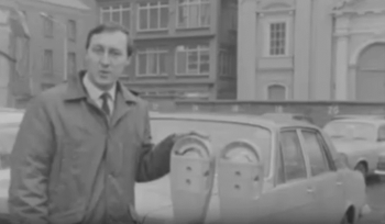 RTE reporter stands beside Duncan parking meters as he talks abou ttheir introduction to Dublin in 1969